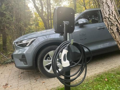 an electric car is hooked up to a car charger at Villa Lena Nagymaros in Nagymaros