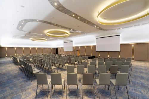a conference room with chairs and a projection screen at Crowne Plaza Belgrade by IHG in Belgrade