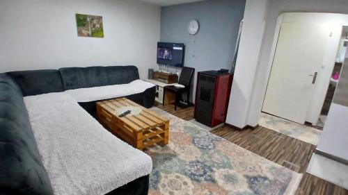 a living room with a couch and a table at Vlašić vikendica BHL in Šišava