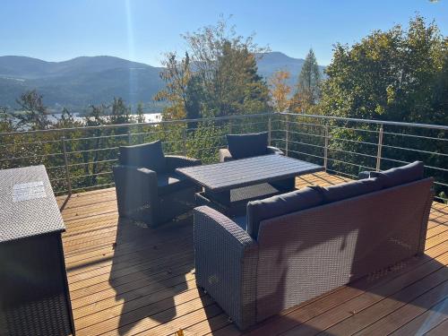 a patio with a table and chairs on a deck at Villa Lena Nagymaros in Nagymaros