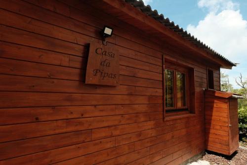 a building with a sign on the side of it at Adega da Quinta -Casa da Pipas in Madalena