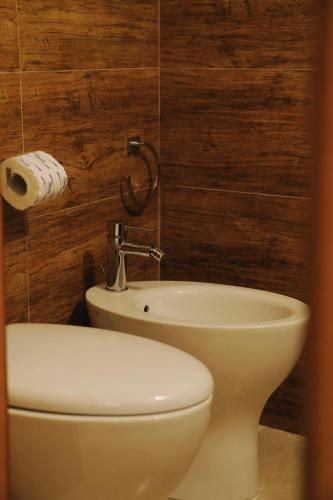 a bathroom with a toilet and a sink at Casa Matteotti in Conversano