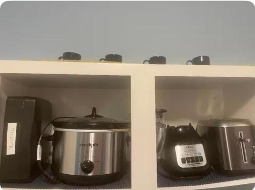 a shelf with pots and pans and a blender at Cozy & Relaxing Near Taos Plaza in Taos