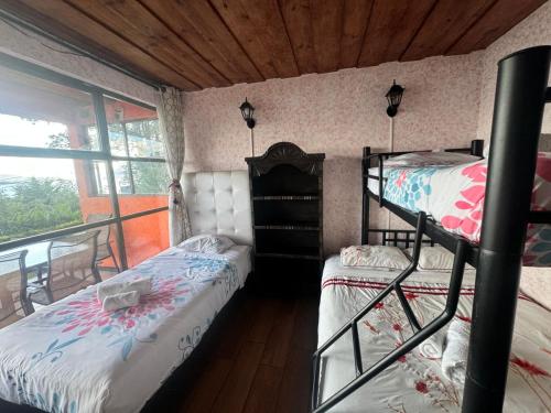 a bedroom with two bunk beds and a balcony at Hanna Suites in Panajachel