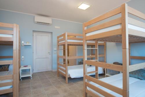 a room with three bunk beds and a hallway at Fattoria Didattica La Collina Incantata in Narni