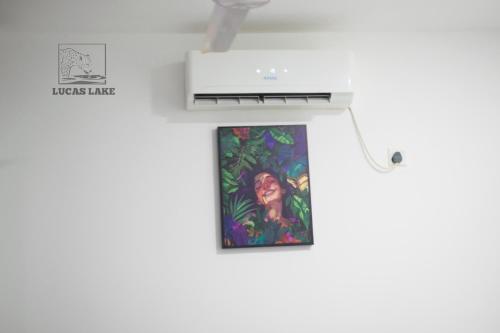 a picture hanging on a wall next to a printer at Yala Lucas Lake Hotel in Tissamaharama