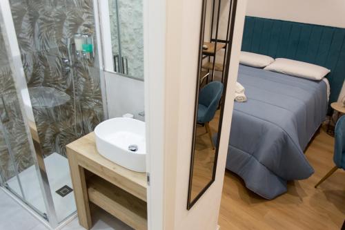 a bathroom with a sink and a bed at La Zagara in Favara