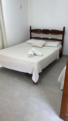 a bedroom with two beds with towels on them at Pousada Do Sol in Porto Seguro