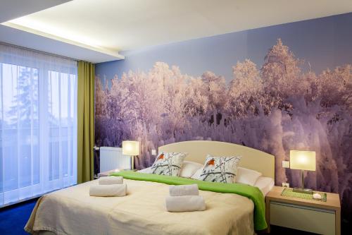 a bedroom with two beds and a purple wall at Hotel Slovan in Vysoke Tatry - Tatranska Lomnica.