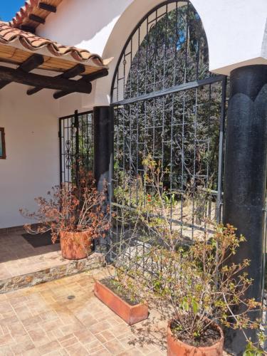 a gate in a courtyard with potted plants at La Casona Cucaita. Sede Campestre in Cucaita