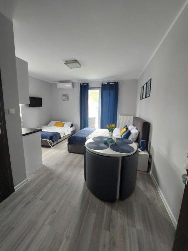 a room with two beds and a table in it at Villa6 in Pobierowo