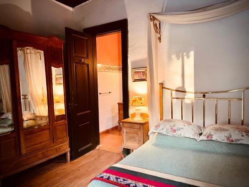 a bedroom with a bed and an open door at Centro Ecuestre Frasco Chico in Lobos