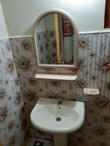 a bathroom with a sink and a mirror at The secound home gesthowse in Hambantota