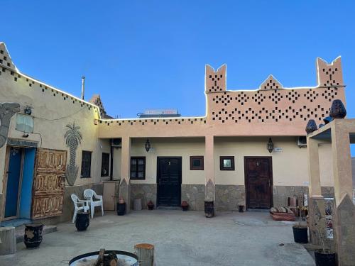a large building with two doors in a courtyard at Auberge & Restaurant Agoudal in Agoudal