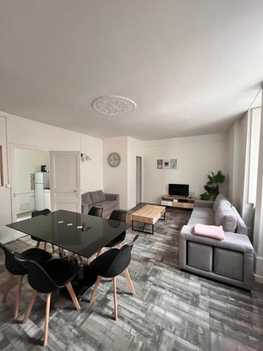 un salon avec une table et un canapé dans l'établissement les nuits du paradis, à Nuits-Saint-Georges