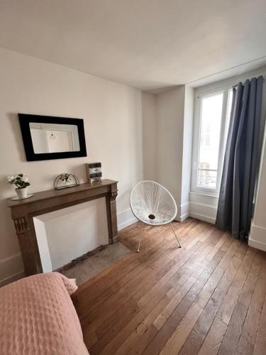 a bedroom with a bed and a fireplace and a window at les nuits du paradis in Nuits-Saint-Georges