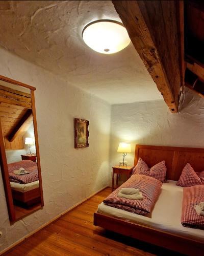 a bedroom with two beds and a large mirror at SCHENE Kammer in Abtenau