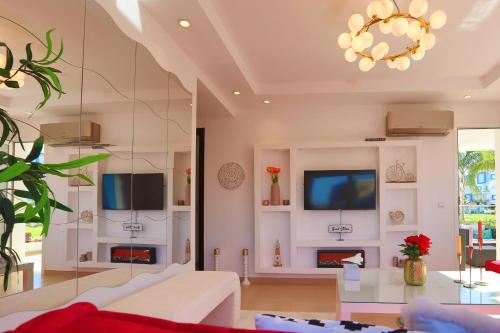 a living room with a white couch and a tv at Smart home in Cabo Negro