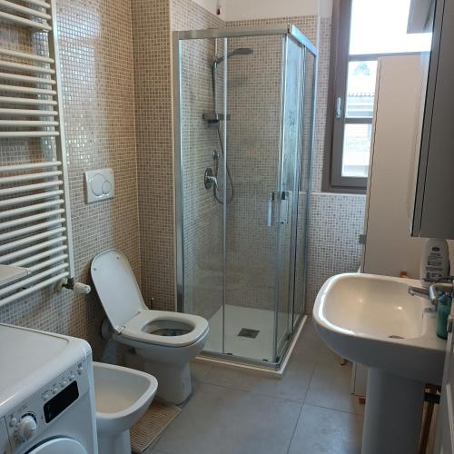 a bathroom with a shower and a toilet and a sink at Two-room apartment with a view Sanctuary in Loreto