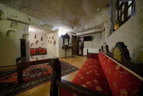 a living room with a couch and a table in a building at Asteria Cave Hotel in Goreme
