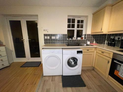 a kitchen with a washing machine in a kitchen at John Lennon Airport house in Liverpool