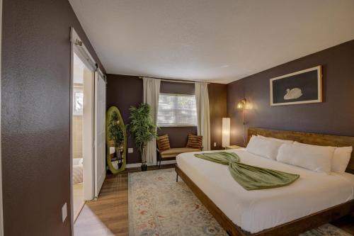 a bedroom with a bed and a chair in it at Vibrant Modern Escape, Walk To Dining, Near Beach in Sarasota