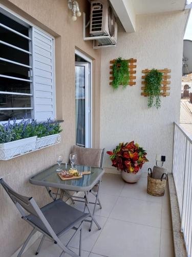 a patio with a table and chairs on a balcony at Hospedagem Quarto Chic centro Cunha in Cunha