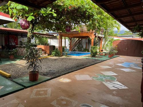 a garden with drawings on the floor of a building at Villas Ela en Bahía Ballena,Uvita Hermosas habitaciones privadas grandes, piscina, cocina, jacuzzi, aire acondicionado, tv y baño privado in Uvita