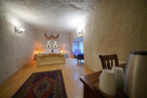 a bedroom with a bed and a table in a room at Asteria Cave Hotel in Goreme