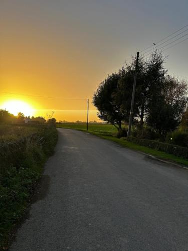 an empty road with the sunset in the background at The Bolthole in Pinchbeck