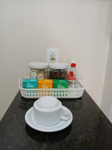 a plate on a counter with a tray of food at Hospedagem Quarto Chic centro Cunha in Cunha