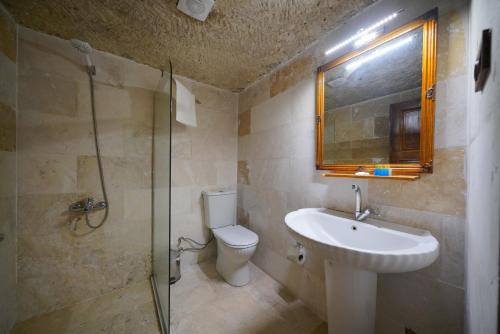 a bathroom with a sink and a toilet and a shower at Asteria Cave Hotel in Goreme
