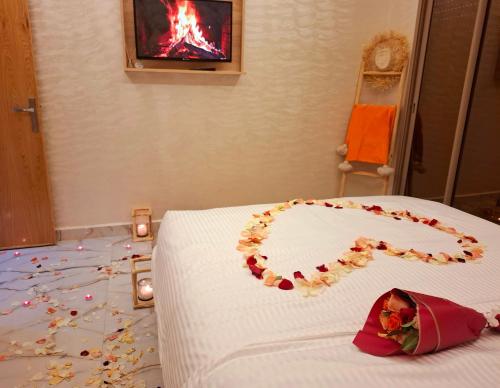 a bedroom with a bed with a flower decoration on the floor at Azur appartement essaouira in Essaouira