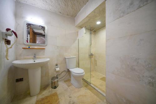 a bathroom with a toilet and a sink and a shower at Asteria Cave Hotel in Goreme