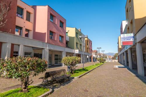 an empty street with a bench and buildings at rest&fly BGY ORIO in Grassobbio