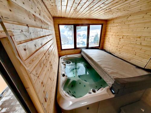 a small bathroom with a tub in the middle at Cabane A-frame CeziAde Tihuta in Piatra Fantanele