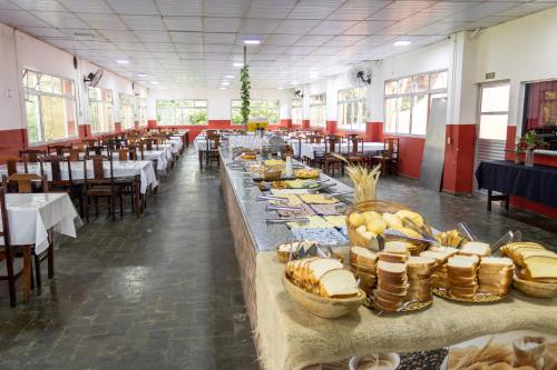a large room with tables with food on them at Ilha Morena Praia Hotel by Concavus in Caraguatatuba