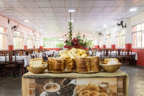 a table with baskets of food in a restaurant at Ilha Morena Praia Hotel by Concavus in Caraguatatuba