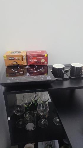 a shelf with wine glasses on a table at Jovanovic Residence Belgrad in Belgrade