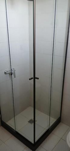 a shower with a glass door in a bathroom at Puerto Yumani in Comunidad Yumani