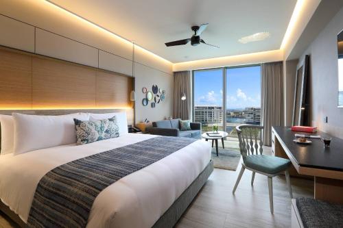 a hotel room with a bed and a desk at Renaissance Cancun Resort & Marina in Cancún