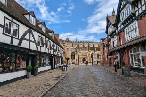 a cobblestone street in an old town with buildings at St Michaels Town House - Elegant and Large Holiday Home in the Heart of Gloucester in Gloucester
