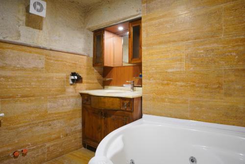 a bathroom with a tub and a sink at Asteria Cave Hotel in Goreme