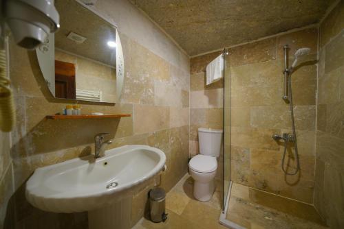a bathroom with a sink and a toilet and a shower at Asteria Cave Hotel in Goreme