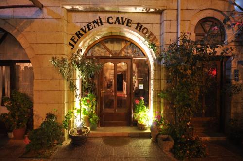 an entrance to a patient care hospital at night at Jerveni Cave Hotel in Mustafapaşa