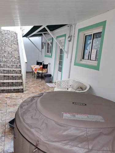 a house with a large table in the middle of a room at VILLA AU COEUR DE LA MARMITE in Sainte-Marie