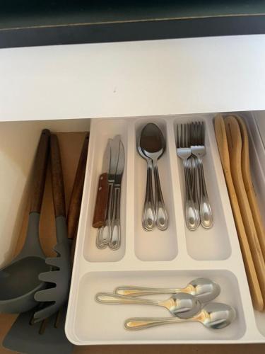 a drawer filled with silver utensils and utensils at Cabañas Aurora in Quilquico