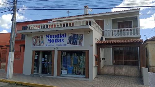 a building with a clothing store on a street at Host Family S in São Gabriel