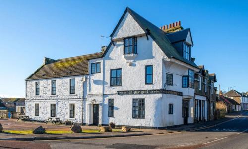 an old white building on the side of a street at Ye Olde Hotel in Leuchars