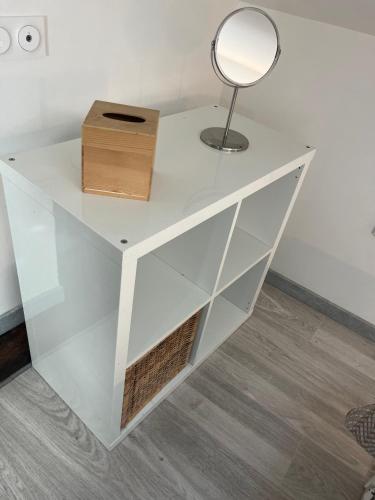 a white table with a mirror and a lamp on it at Le Terrier in Mussidan